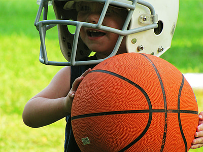 closeup photo of wearing NFL helmet holding a basketball thumbnail