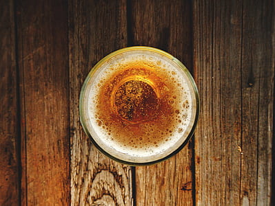 liquid-filled round cup on brown plank thumbnail