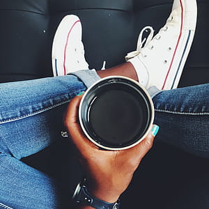 Top View Photo of Person Holding Cup thumbnail