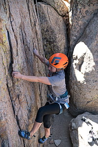 person climbing wall during daytime thumbnail