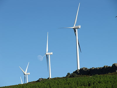 three white windmills under blue sky during daytime thumbnail