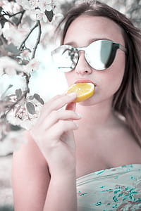 woman eating yellow sliced lemon thumbnail