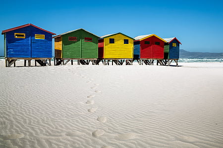 five assorted-color beachside cabins thumbnail