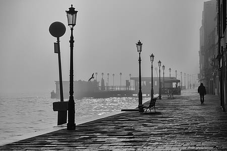 person walking in street with lamps thumbnail