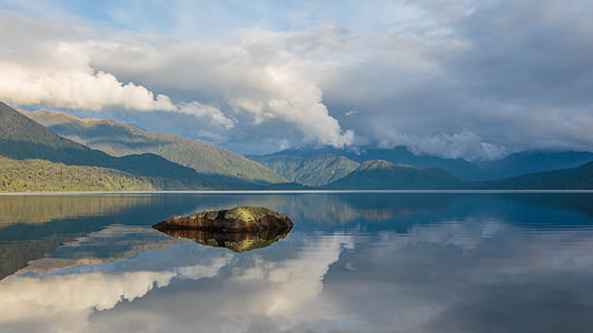 body of water under grey cloudy sky thumbnail