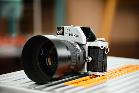 grey and black Nikon F SLR camera on grey surface thumbnail