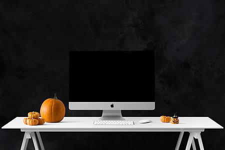 silver iMac near pumpkin on table thumbnail
