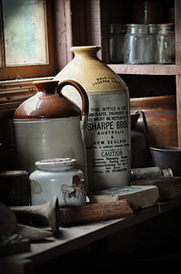 several stoneware jugs on wooden table near rack thumbnail