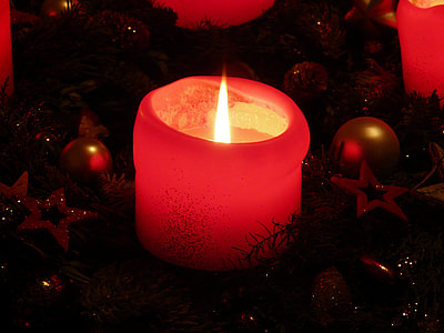 lit candle surrounded by baubles thumbnail