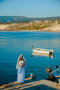 bride standing near body of water during daytime thumbnail