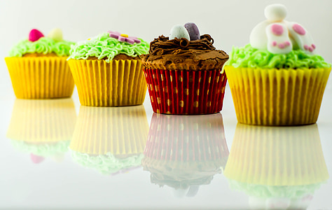 closeup photo of four cupcake on white surface thumbnail