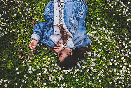 woman laying on white flowers thumbnail