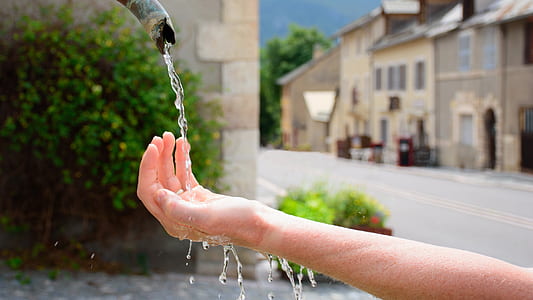 person's hand filling water flow thumbnail