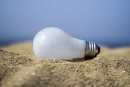 close-up photography of white bulb on brown sand thumbnail