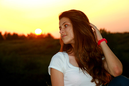woman holding hair while looking sideways thumbnail