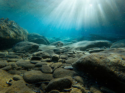 stones under body of water thumbnail