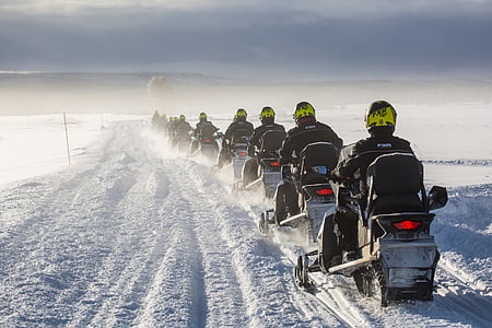 crowded people riding vehicle on snowfield at daytime thumbnail