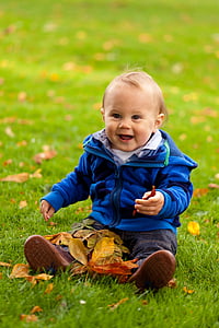 toddler wearing blue zip-up jacket smiling thumbnail