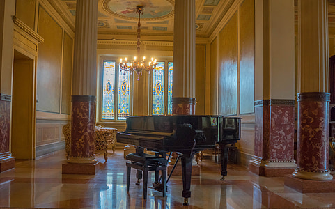 black grand piano on gray hall thumbnail