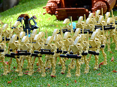 beige action figure lot on green grass thumbnail