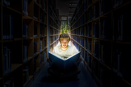 man reading book in library room thumbnail