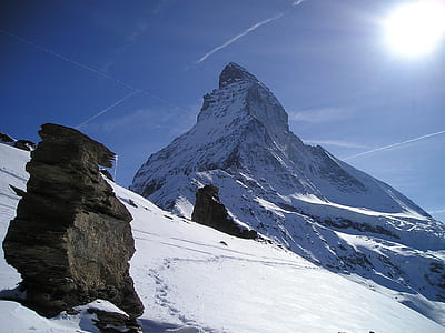 mountain covered by snow during daytime thumbnail