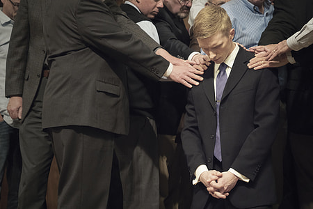 people holding man's shoulder that kneels thumbnail