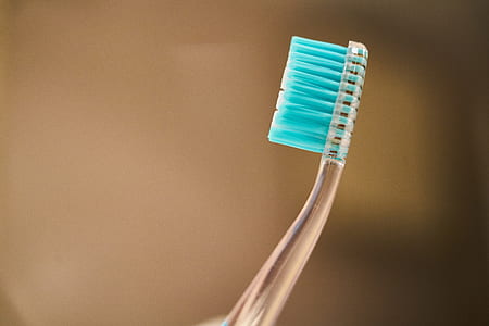 blue toothbrush selective focus photography thumbnail