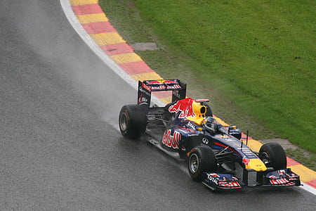 blue and yellow Redbull F1 on road at daytime thumbnail