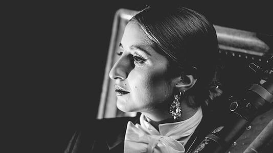 woman wearing bow accent top grayscale photogra[hy thumbnail