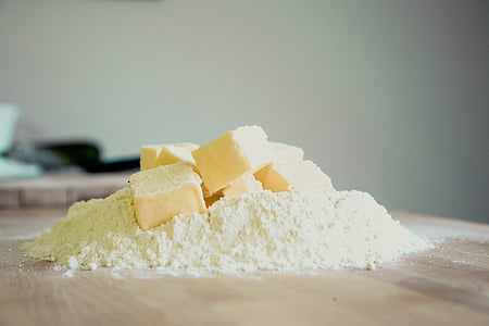 sliced and powder cheese on brown wooden surface thumbnail