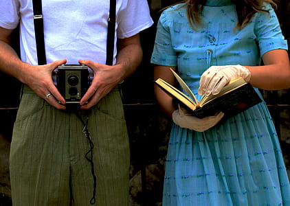 woman in blue dress holding black book thumbnail