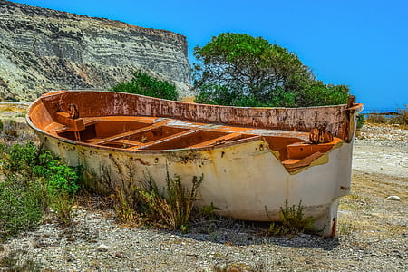brown metal boat docked on gray land thumbnail