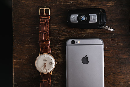 Apple iPhone 6 and Vintage watch on a brown leather wallet thumbnail