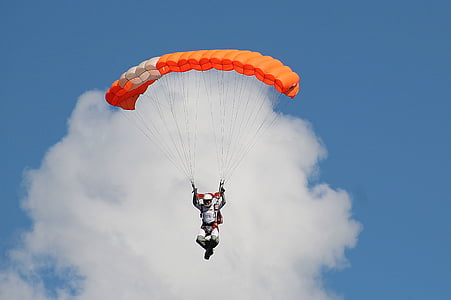 man in paragliding during daytime thumbnail