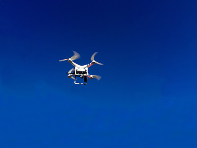 white and red quadcopter is flying during daytime thumbnail