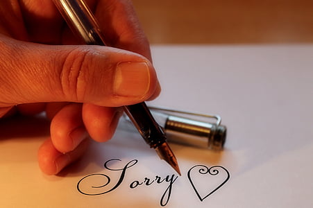 person writing on white paper thumbnail