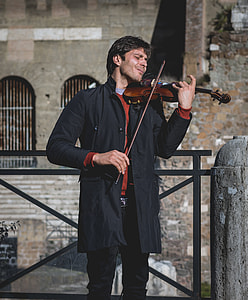 man playing brown violin with bow thumbnail