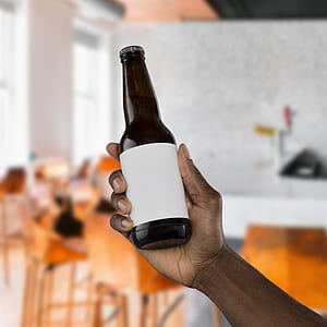 person holding liquor bottle thumbnail