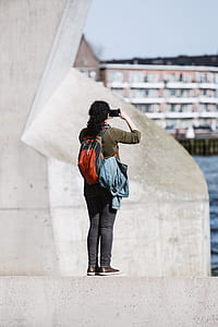 woman taking photo of building thumbnail
