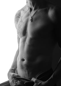 grayscale photo of man in denim bottoms thumbnail