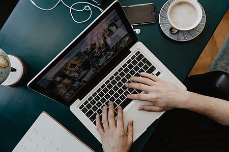 Male working with a laptop and a cup of coffee thumbnail