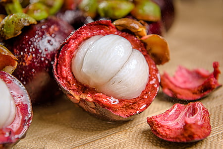 mangoosten fruit on brown surface thumbnail