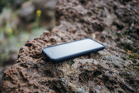 black iPhone 7 and black case on brown surface thumbnail