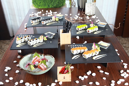 sushis served on black trays on brown table thumbnail