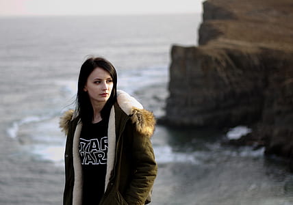 woman standing near body of water thumbnail