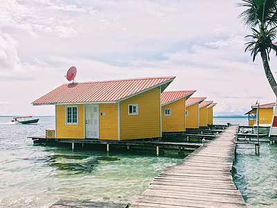 photo of brown houses on sea during day time thumbnail