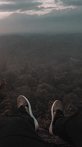 Person Sitting on the Edge of Mountain thumbnail
