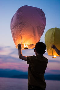 boy holding floating lantern thumbnail