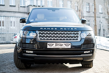 black Land Rover Range Rover SUV on brick road at daytime thumbnail